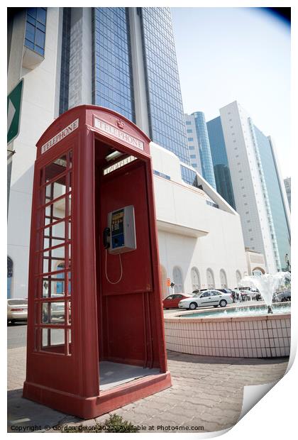 An old British telephone box stood on the pavement in Dubai  Print by Gordon Dixon