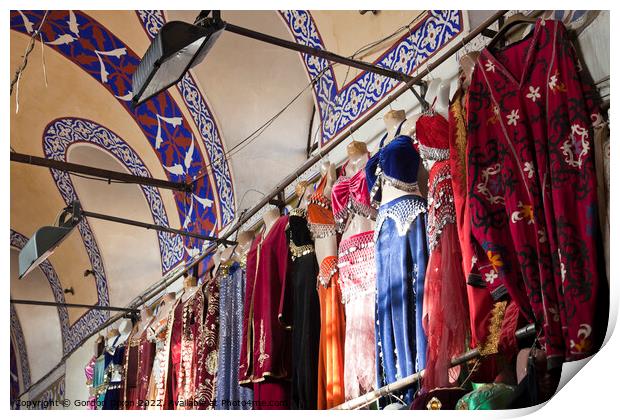 Clothing stall inside Istanbul's ornate Grand Bazzar Print by Gordon Dixon