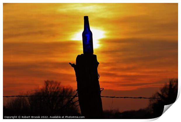 Sunset with a bottle on a fence post with sky. Print by Robert Brozek