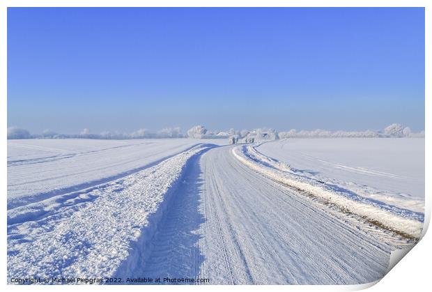 View of a snow-covered country road in winter with sunshine and blue sky Print by Michael Piepgras