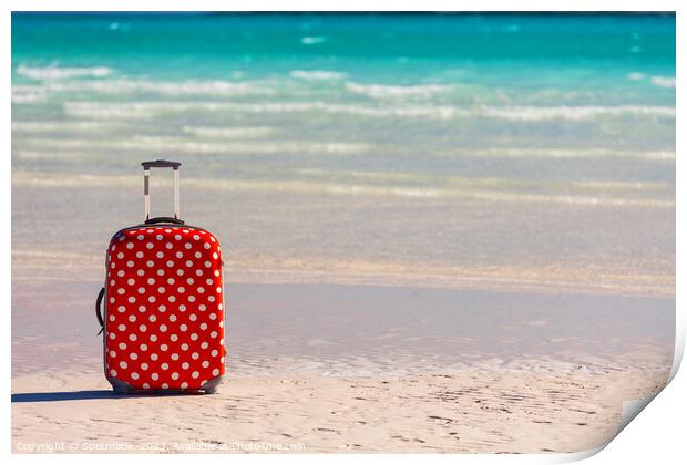 Red polka dot travel luggage on sand beach Print by Spotmatik 