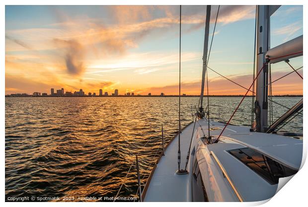 Yacht sailing towards cityscape on horizon at sunset Print by Spotmatik 