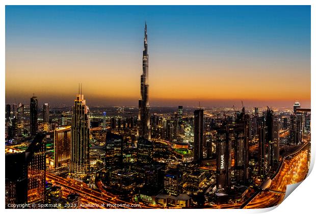 Aerial illuminated Dubai at sunset Burj Khalifa UAE Print by Spotmatik 