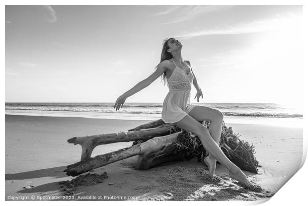 Young beach girl enjoying sun sitting on driftwood  Print by Spotmatik 