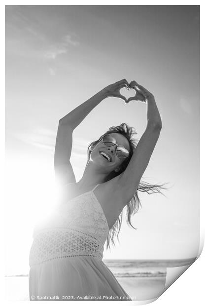 Bohemian girl dancing on beach showing heart sign Print by Spotmatik 