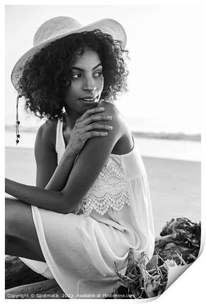 Solo African American woman sitting on beach driftwood Print by Spotmatik 