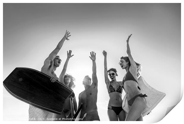 Friends in swimwear carrying bodyboards celebrating fun activity Print by Spotmatik 