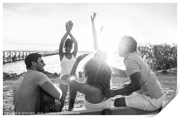 Friends dancing to guitar music outdoors at sunset Print by Spotmatik 
