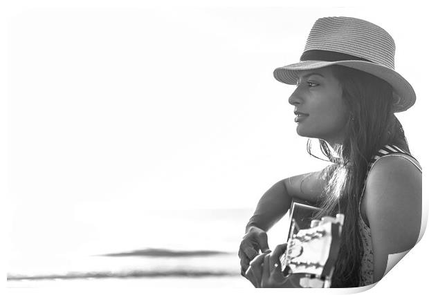 Indian woman wearing hat playing guitar on beach Print by Spotmatik 