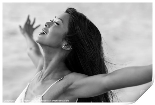 Asian girl enjoying freedom outdoors by the ocean Print by Spotmatik 