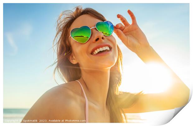 Caucasian girl wearing heart shaped sunglasses on beach Print by Spotmatik 