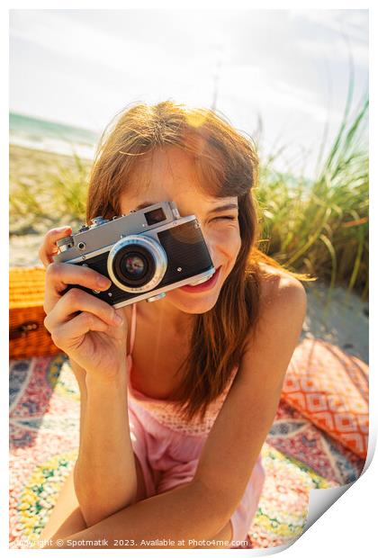 Smiling Caucasian girl with camera photographing beach vacation Print by Spotmatik 