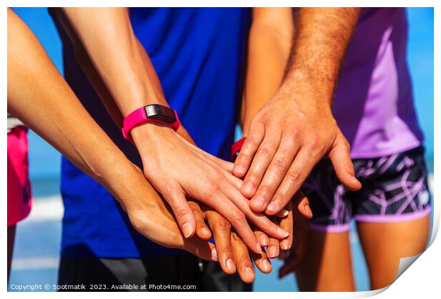 Multi ethnic friends joining hands after beach workout Print by Spotmatik 