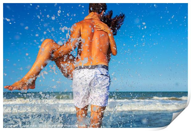 Fun loving ethnic couple running in ocean waves Print by Spotmatik 