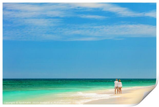 Retired couple walking barefoot by turquoise ocean Bahamas Print by Spotmatik 