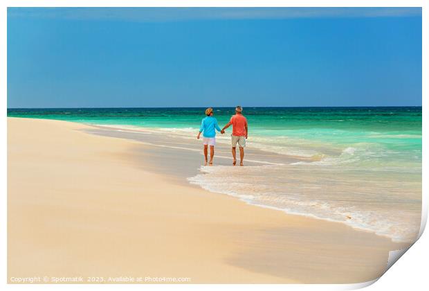 Mature couple paddling on tropical island shoreline Bahamas Print by Spotmatik 