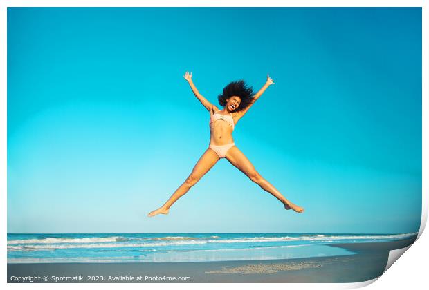 Healthy African American girl jumping high on beach Print by Spotmatik 