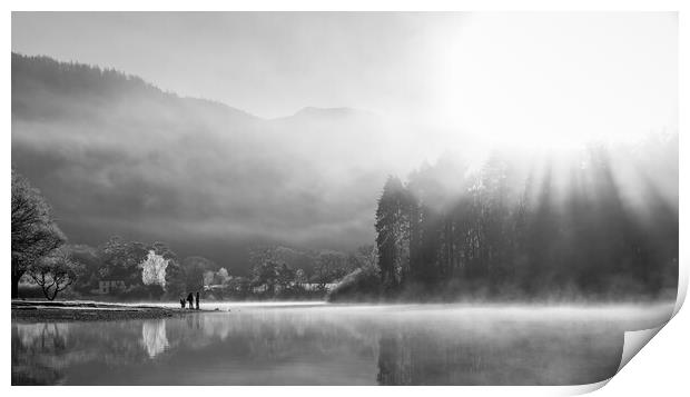 Family playing on shores of Derwent Water on a cold winters morning with mist and sun beams Print by Julian Carnell