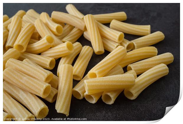 Raw italian penne rigate pasta isolated on black background Print by Lubos Chlubny