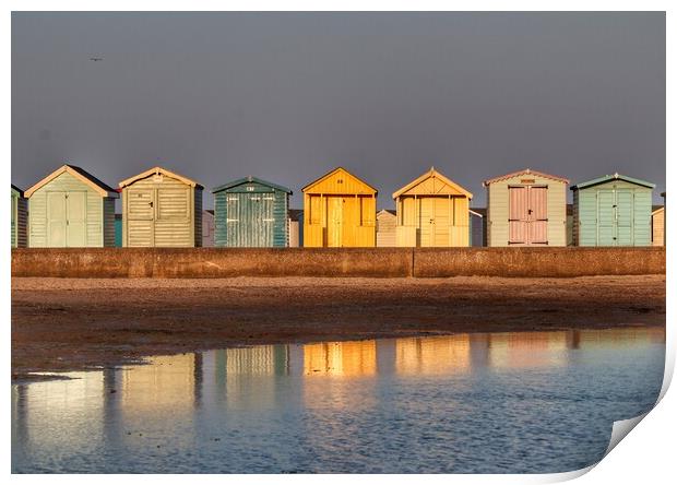Beach huts basking in a Brightlingsea  Sunset  Print by Tony lopez