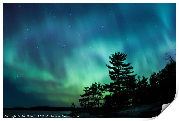 Northern lights erupt over a lake in Minnesota in a dark sky ove Print by Rob Schultz