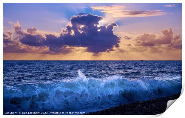 Sunset from Brighton beach with light glistening on the sea spray Print by Iain Lockhart