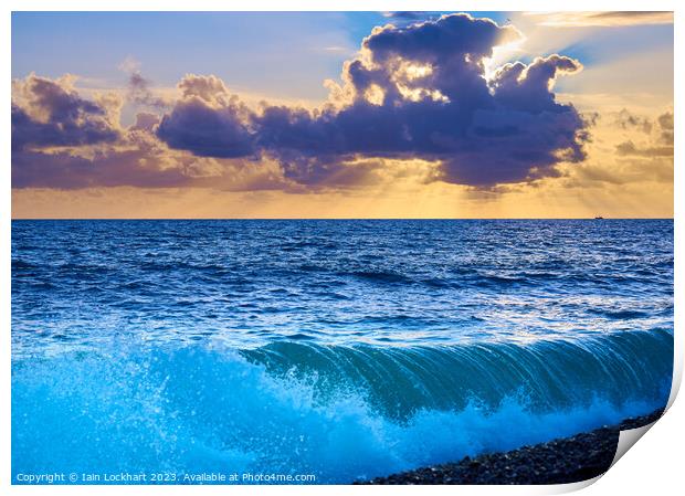 Sunset from Brighton beach with light glistening on rolling waves Print by Iain Lockhart