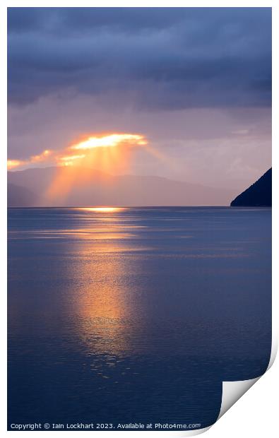 A sunburst over a Norwegian fjord Print by Iain Lockhart