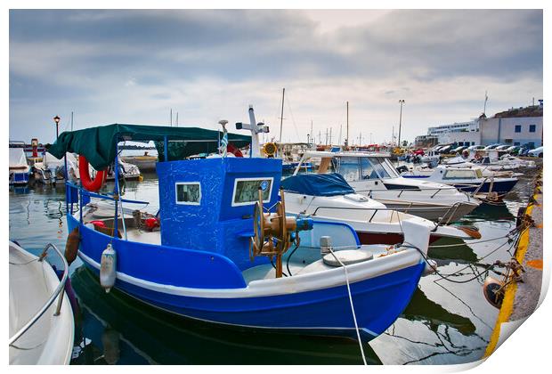 Greek fishing boats stays parked near sea pier at Vlychada town  Print by Olga Peddi