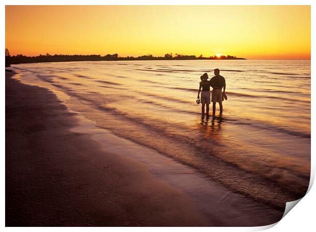 couple along beach at sunset Print by Dave Reede