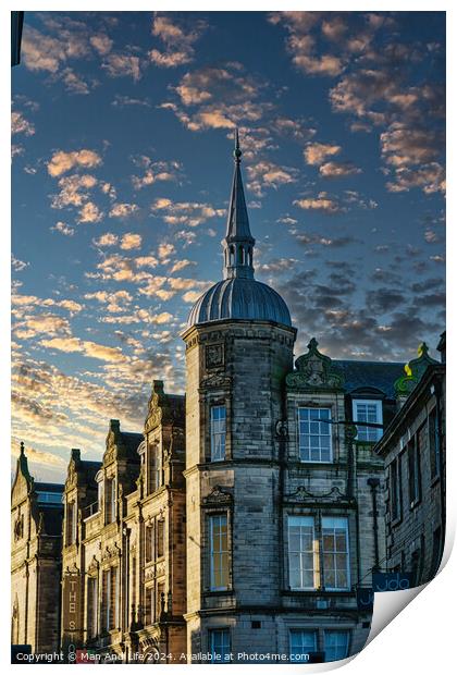 Historic building with a spire against a dramatic sky with golden sunset clouds in Lancaster. Print by Man And Life