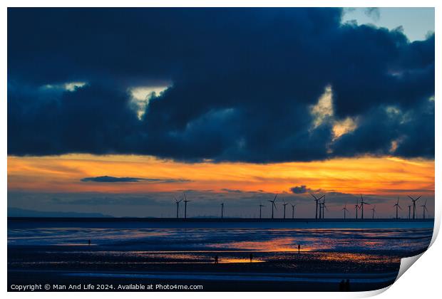 Dramatic sunset over a beach with silhouetted wind turbines on the horizon and reflective wet sand in Crosby, England. Print by Man And Life