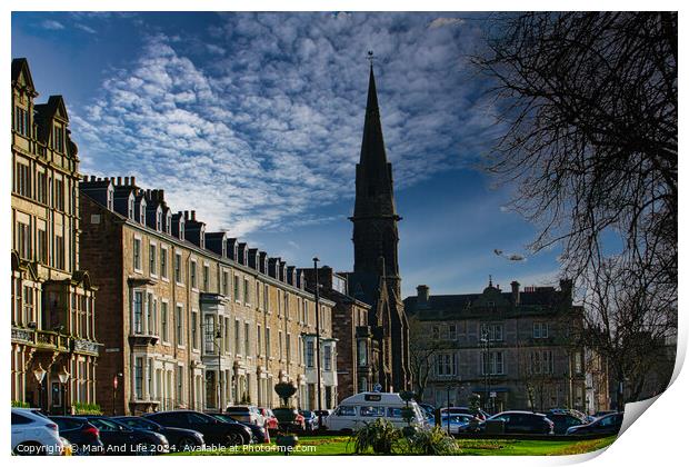 Classic European street with historic architecture and a church spire under a dramatic cloudy sky in Harrogate, England. Print by Man And Life
