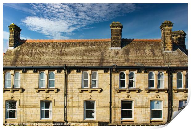 Traditional brick row houses under blue sky with wispy clouds in Harrogate, England. Print by Man And Life