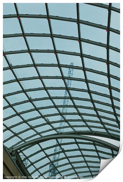 Abstract view of a glass ceiling with a metal frame, showcasing geometric patterns and a clear blue sky in the background. Print by Man And Life