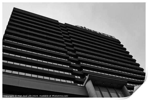 Modern black and white architectural photograph of a high-rise building with a patterned facade against a cloudy sky in Leeds, UK. Print by Man And Life