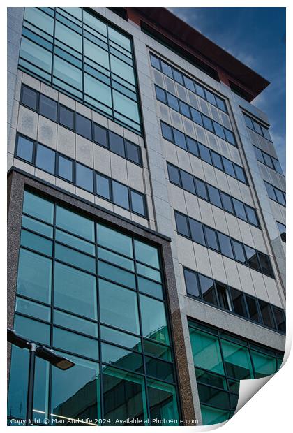 Modern office building facade with reflective glass windows against a blue sky in Leeds, UK. Print by Man And Life