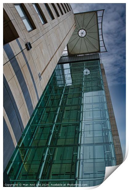 Modern architectural detail with glass facade and clock tower against a blue sky in Leeds, UK. Print by Man And Life