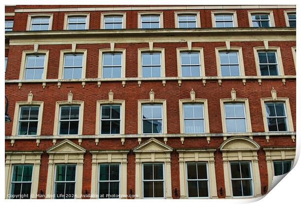 Facade of a classic red brick building with symmetrical windows against a clear sky in Leeds, UK. Print by Man And Life