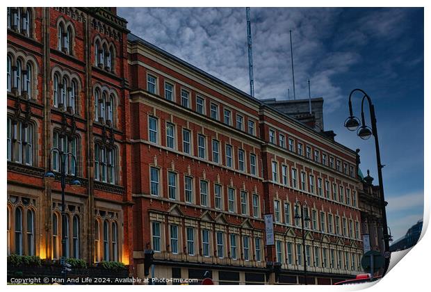 Historic red brick building at dusk with street lamp and dramatic sky in Leeds, UK. Print by Man And Life