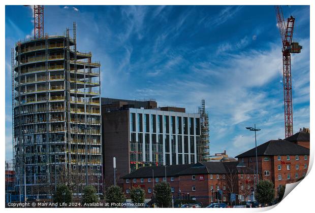 Urban construction site with cranes and developing high-rise building against a blue sky with wispy clouds in Liverpool, UK. Print by Man And Life