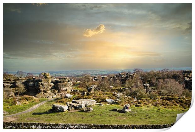 Picturesque rural landscape at sunset with rocky formations and green fields under a cloudy sky at Brimham Rocks, in North Yorkshire Print by Man And Life