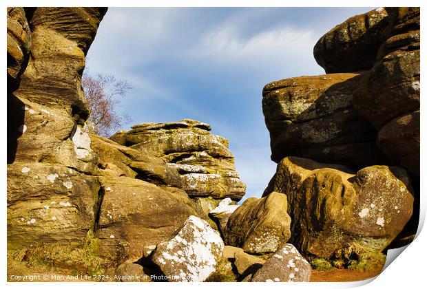 Scenic view of weathered rock formations under a blue sky with clouds at Brimham Rocks, in North Yorkshire Print by Man And Life