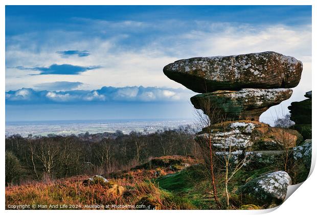 Scenic view of a unique rock formation in a lush landscape with dramatic clouds in the sky at Brimham Rocks, in North Yorkshire Print by Man And Life