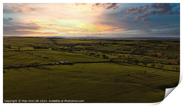 Aerial view of a lush green countryside under a dramatic sunset sky in North Yorkshire. Print by Man And Life