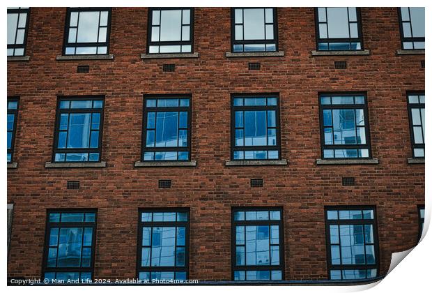 Symmetrical brick building facade with rows of blue windows, urban architecture background in Leeds, UK. Print by Man And Life