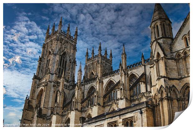 Gothic cathedral tower against a dramatic cloudy sky, showcasing intricate architectural details and spires, ideal for historical or religious themes in York, North Yorkshire, England. Print by Man And Life