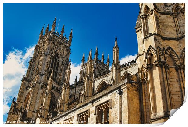 Majestic Gothic cathedral against a blue sky with clouds, showcasing intricate architecture and historical religious significance in York, North Yorkshire, England. Print by Man And Life