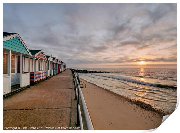 UK, Suffolk, Southwold, colourful beach huts and promenade at sunrise Print by Liam Grant