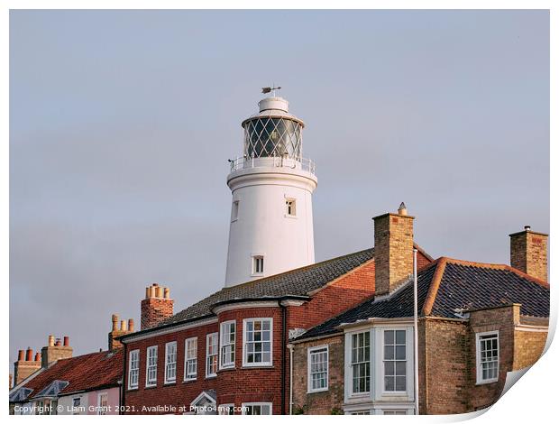 UK, Suffolk, Light from the sunrise on southwold lighthouse Print by Liam Grant